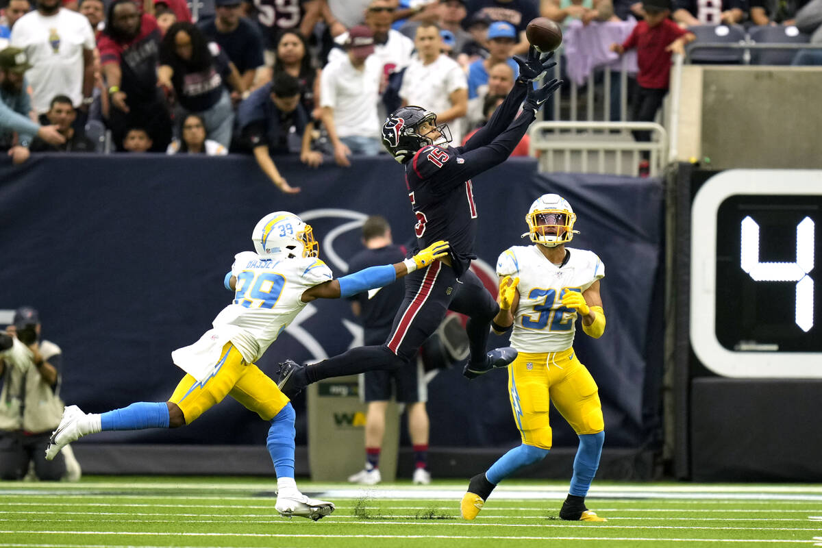 Houston Texans wide receiver Chris Moore (15) catches a pass as Los Angeles Chargers' Essang Ba ...