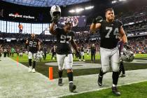 Raiders defensive tackle Damion Square (97) and offensive tackle Kolton Miller (74) celebrate a ...