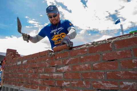 Competitor Jacob Ramirez of Houston, Texas, works his bricks and mortar in the Spec Mix Brickla ...