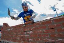Competitor Jacob Ramirez of Houston, Texas, works his bricks and mortar in the Spec Mix Brickla ...