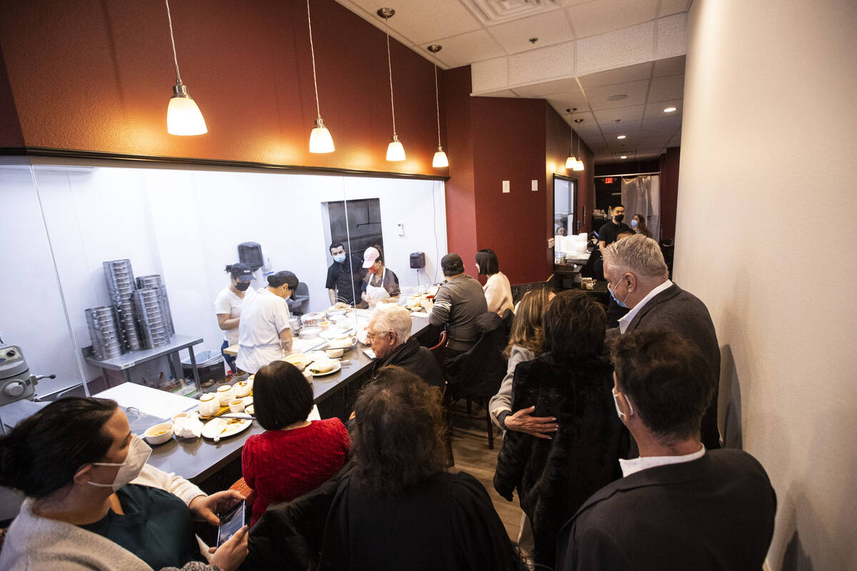 Gov. Steve Sisolak, far right, visits ShangHai Taste after a press conference held with the Asi ...