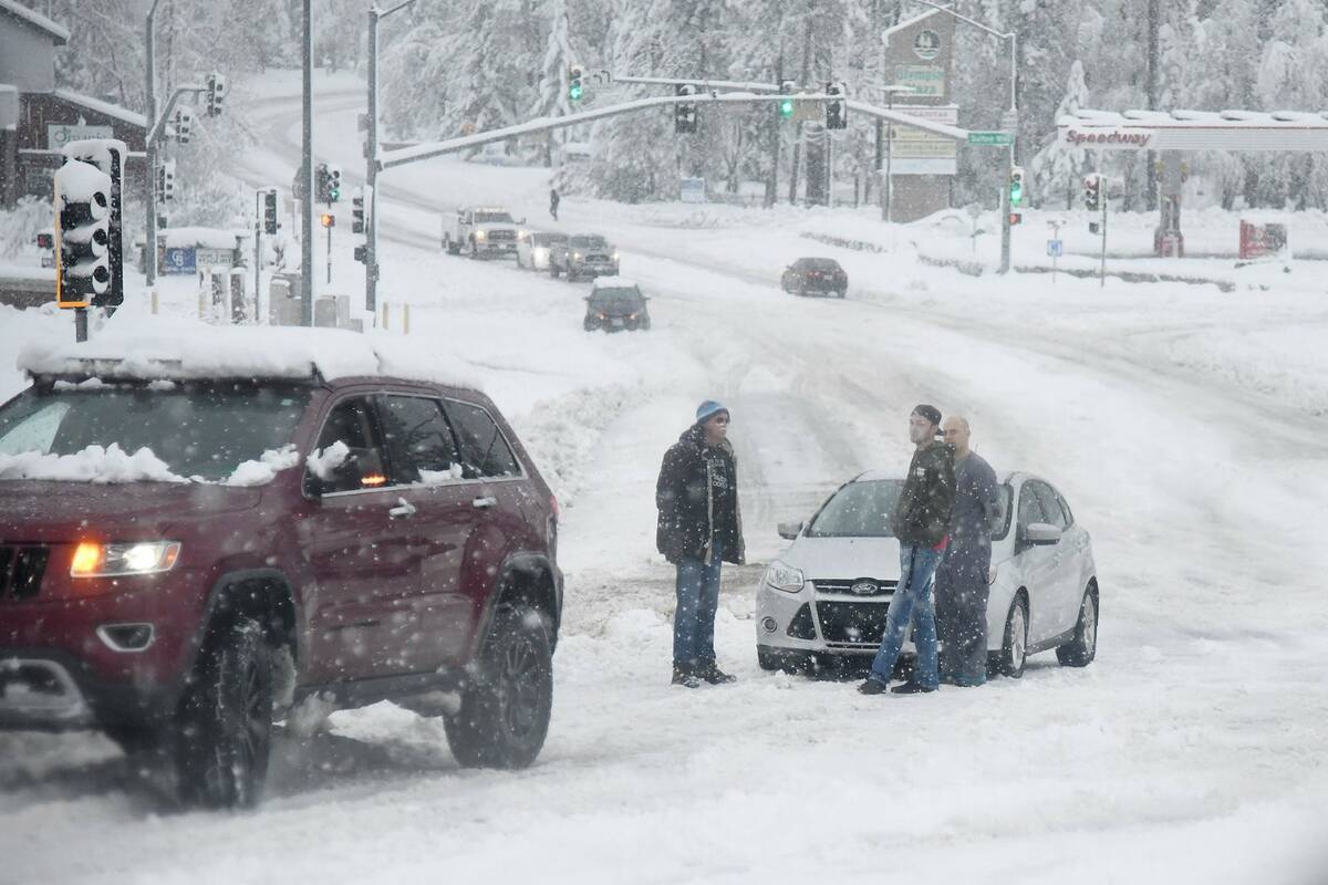 Stuck motorists are seen along Brunswick Road as heavy snow continues to fall early Monday, Dec ...