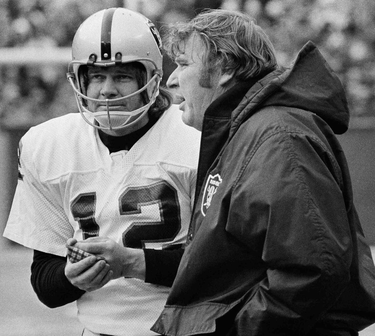 In this Jan. 4, 1976, file photo, Oakland Raiders quarterback Ken Stabler rubs his hands to war ...