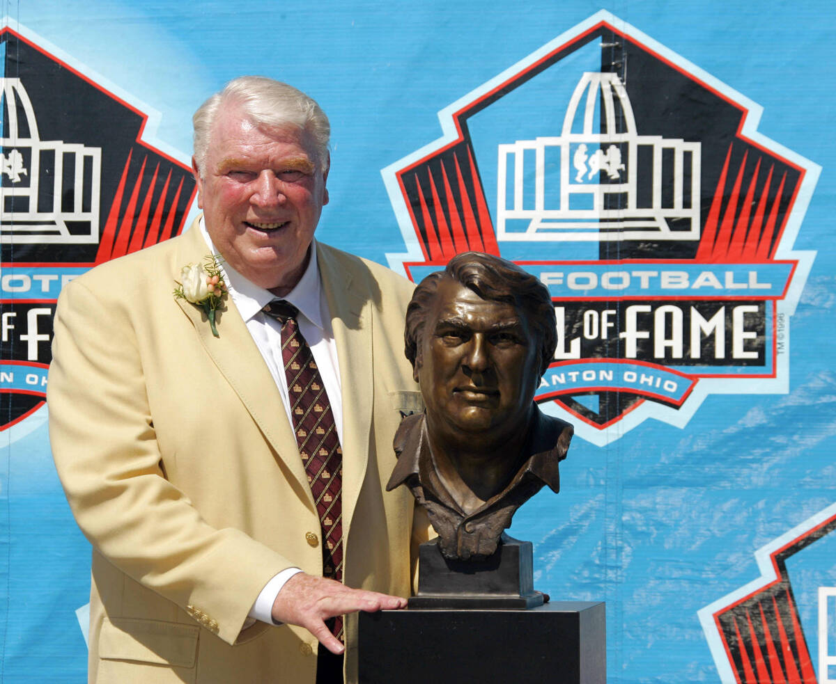 Broadcaster and former Oakland Raiders coach John Madden poses with his bust after enshrinement ...