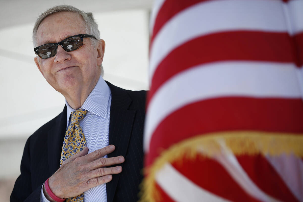 U.S. Senator Harry Reid, D-Nev., listens to the nationalist  anthem during a groundbreaking ceremon ...