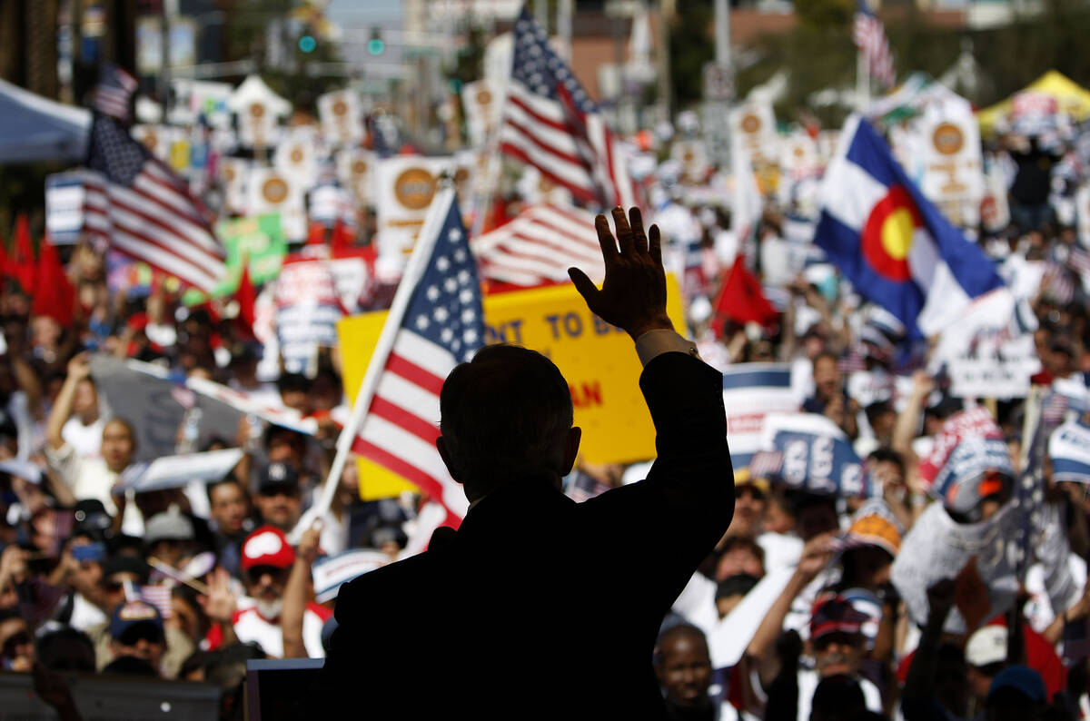 U.S. Senator Harry Reid, D-Nev., waves to a assemblage  of protesters during an migration  betterment   ra ...