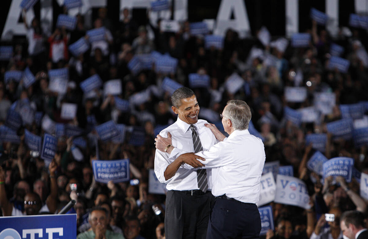 President Barack Obama embraces U.S. Senator Harry Reid, D-Nev., during a rally astatine  Orr Middle S ...