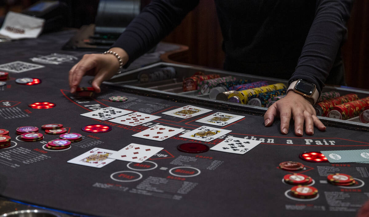 A dealer works the table as guests play Ultimate Texas Hold’Em at Red Rock Casino on Tue ...