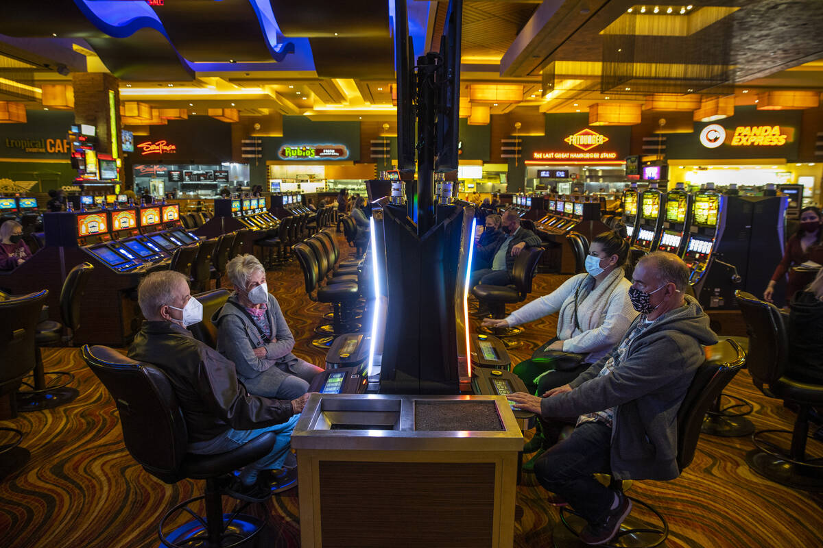 Gary Correa of Los Angeles, bottom right, joins others inn playing slots at Red Rock Casino on ...