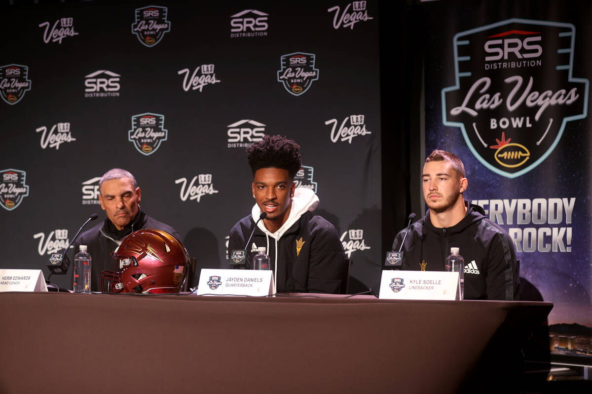Arizona State coach Herm Edwards, from left, quarterback Jayden Daniels and linebacker Kyle Soe ...