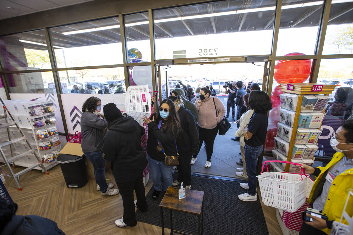 Customers, including Jade Esguerra, center, of Las Vegas, make their way into Daiso, a popular ...