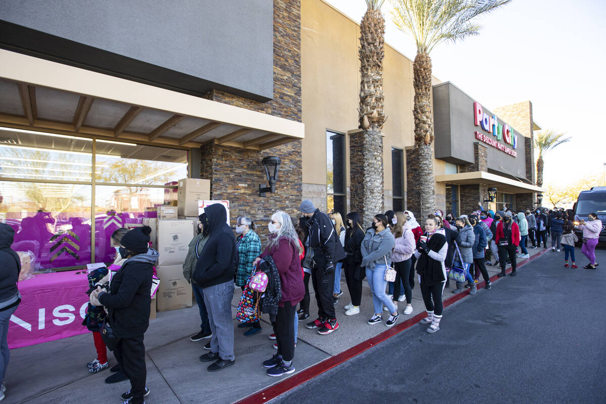 Customers line up to enter Daiso, a popular Japanese discount store, during the grand opening o ...