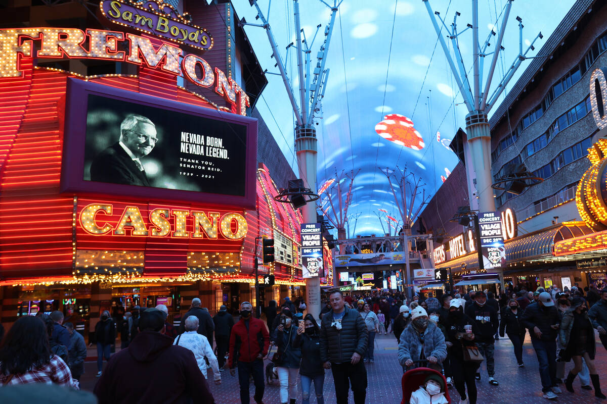 Former U.S. Sen. Harry Reid is shown a video board on the Fremont at the Fremont Street Experie ...