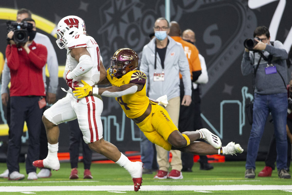 Arizona State Sun Devils defensive back Evan Fields (4) jumps to tackle Wisconsin Badgers runni ...