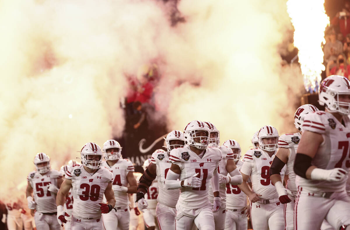 Wisconsin Badgers players enter the field before the start of the Las Vegas Bowl NCAA college f ...