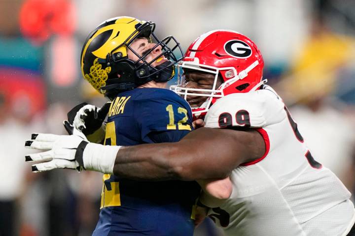 Georgia defensive lineman Jordan Davis hits Michigan quarterback Cade McNamara during the secon ...