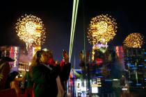 Revelers watch at Drai's nightclub as fireworks explode on the Las Vegas Strip during a New Yea ...