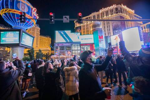 People gather to celebrate New Year's Eve on the Las Vegas Strip on Dec. 31, 2020. (Elizabeth P ...