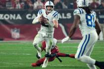 Indianapolis Colts quarterback Carson Wentz (2) is tripped up by Arizona Cardinals safety Budda ...