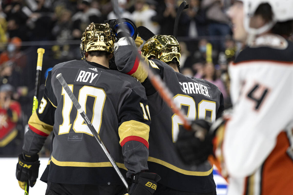 Golden Knights left wing William Carrier (28) congratulates center Nicolas Roy (10) after he sc ...