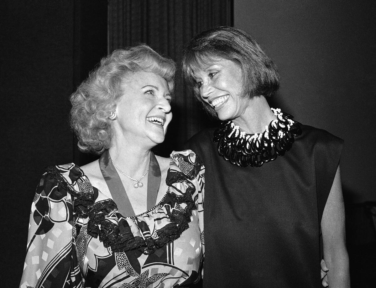 Actresses Betty White Ludden, left, and Mary Tyler Moore, right, smile at each other in Los Ang ...