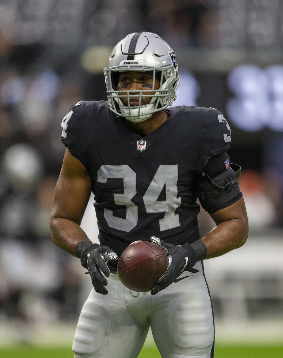 Raiders outside linebacker K.J. Wright (34) holds on to the football before an NFL football gam ...