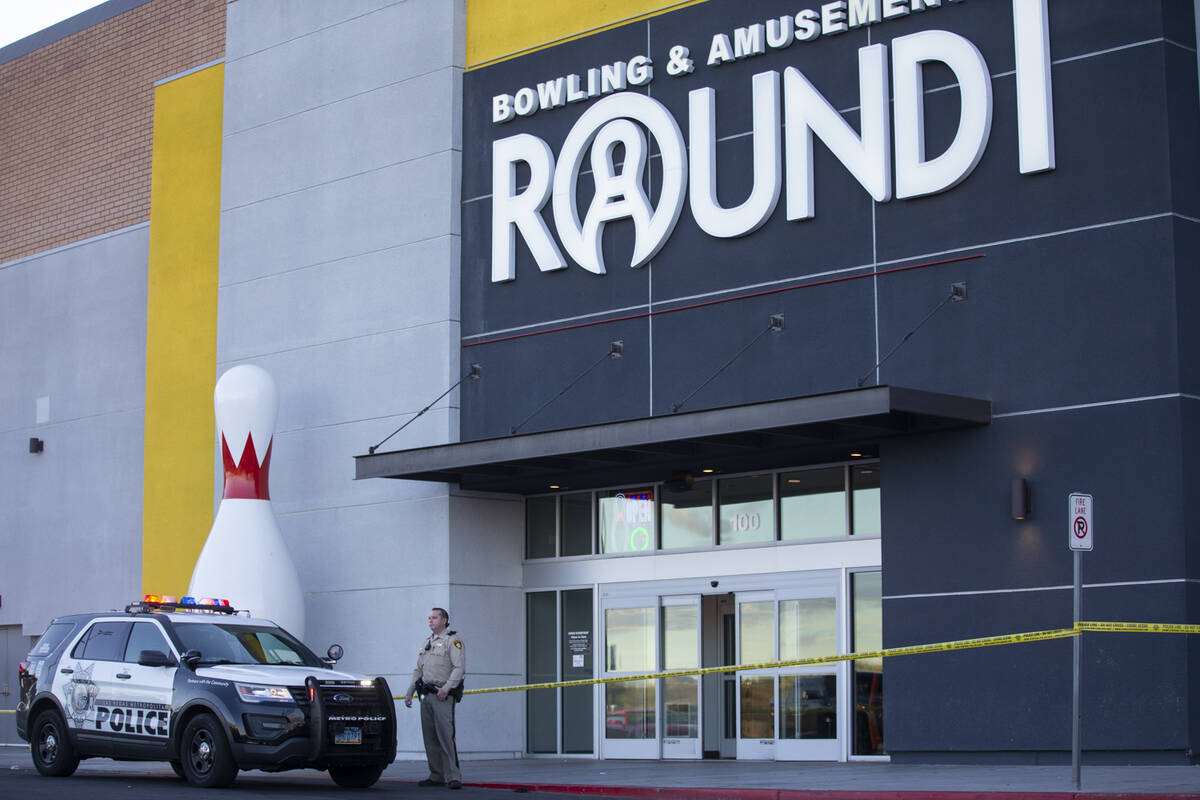 Las Vegas police officers investigate the scene of a shooting at Meadows Mall in Las Vegas, Fri ...