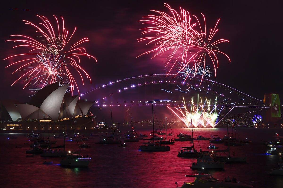 Fireworks explode over the Sydney Opera House and Harbour Bridge as New Year's Eve celebrations ...