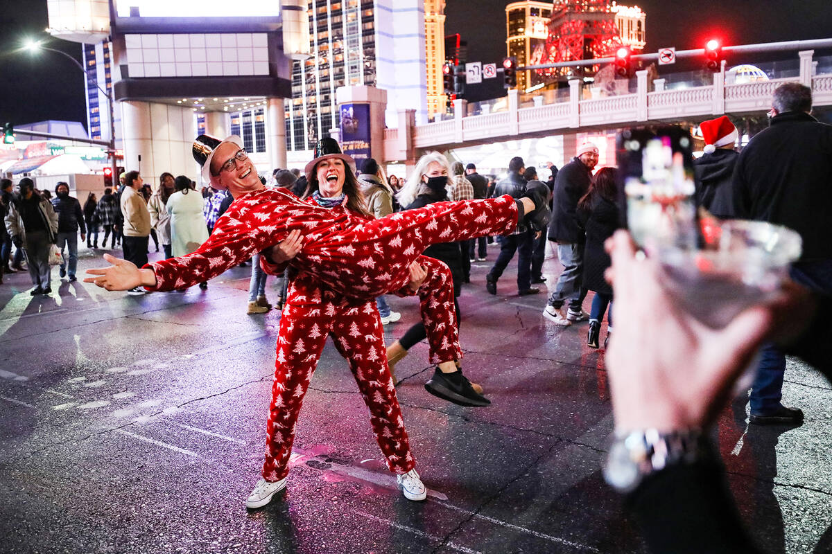 Kate Greenhouse holds her boyfriend Andrew Mott, both of San Diego, for a photo on the Strip in ...