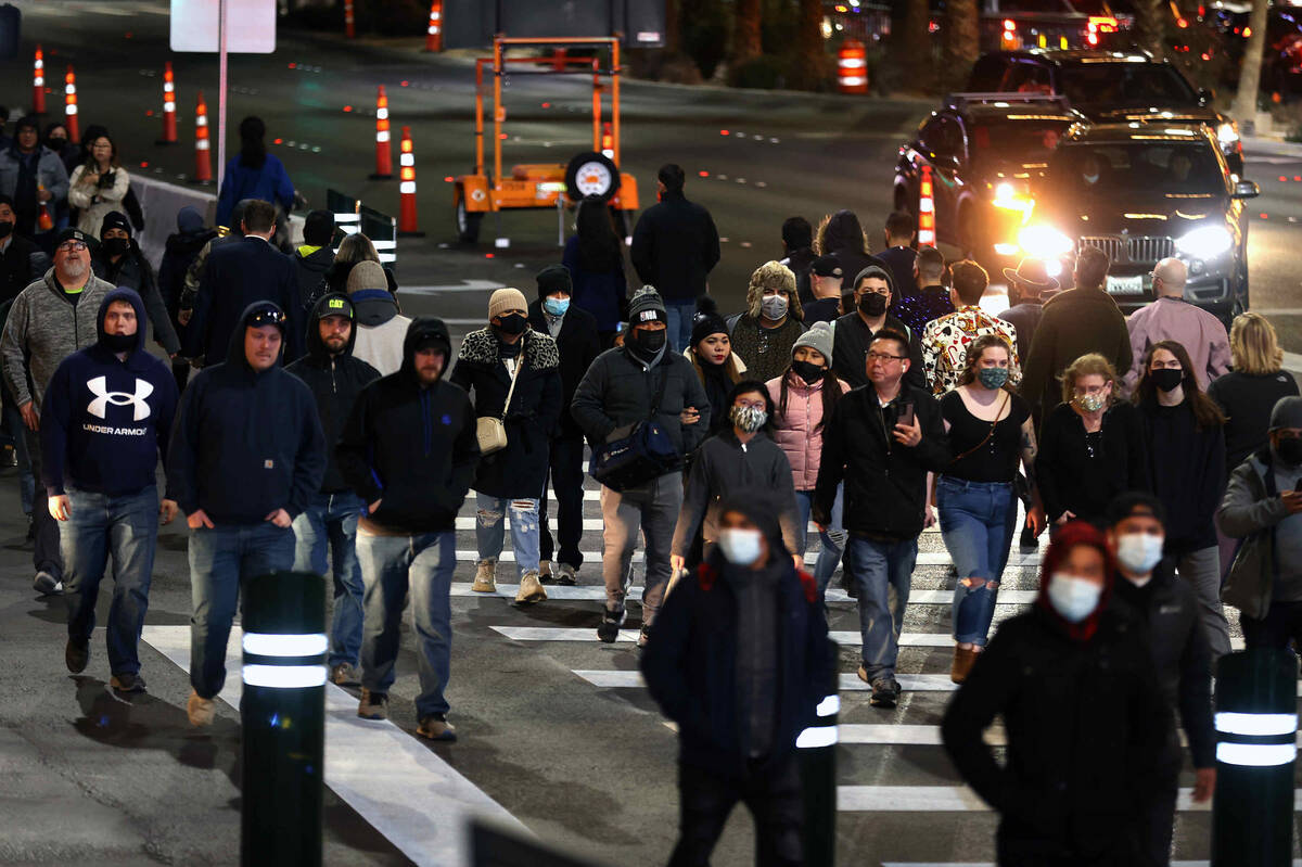 Pedestrians walk along S. Las Vegas Blvd. near Fashion Show Mall during New Year’s Eve o ...