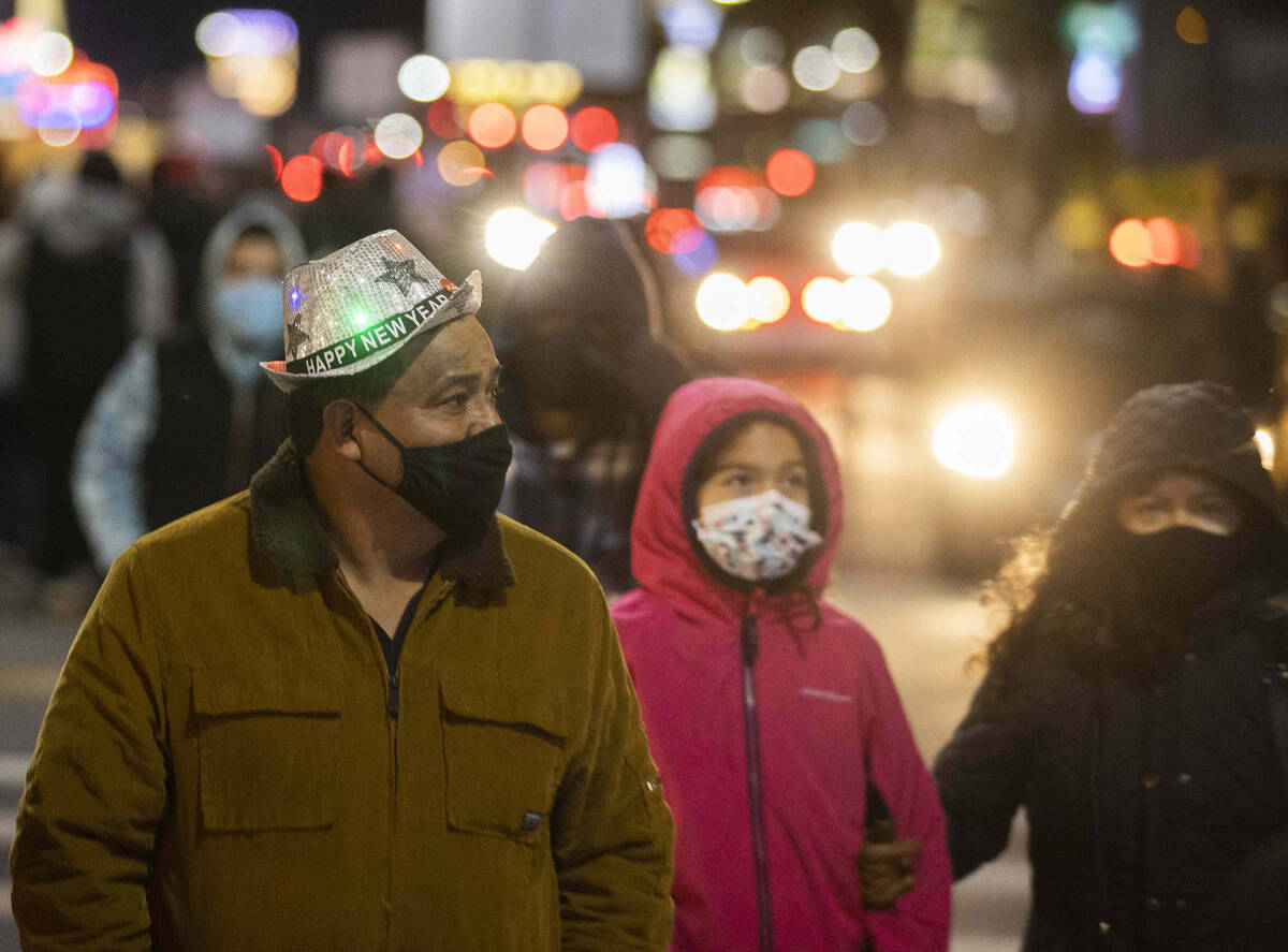 New Year’s Eve crowds walk the Strip on Friday, Dec. 31, 2021, in Las Vegas.(Benjamin Ha ...