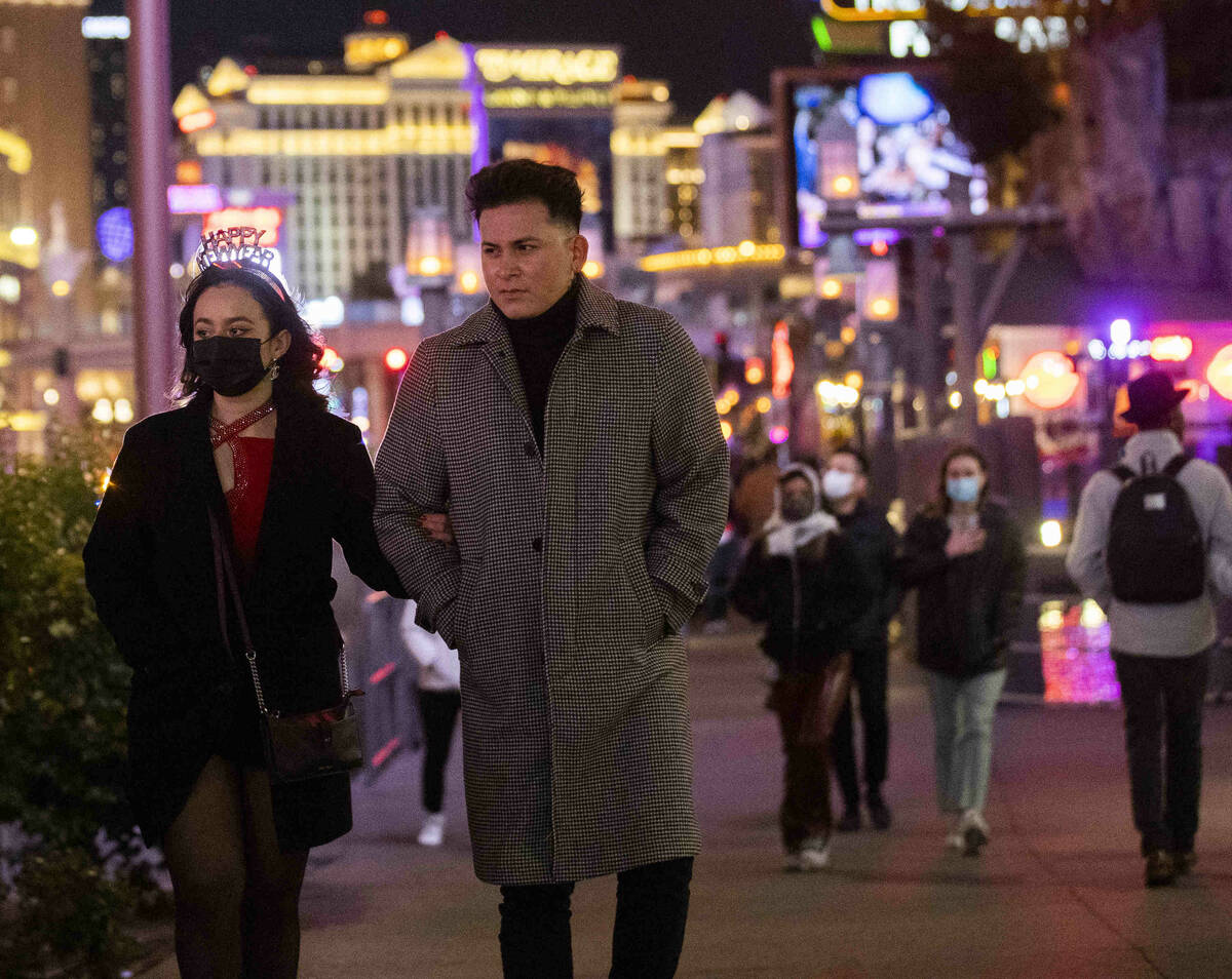 New Year’s Eve crowds walk the Strip on Friday, Dec. 31, 2021, in Las Vegas.(Benjamin Ha ...