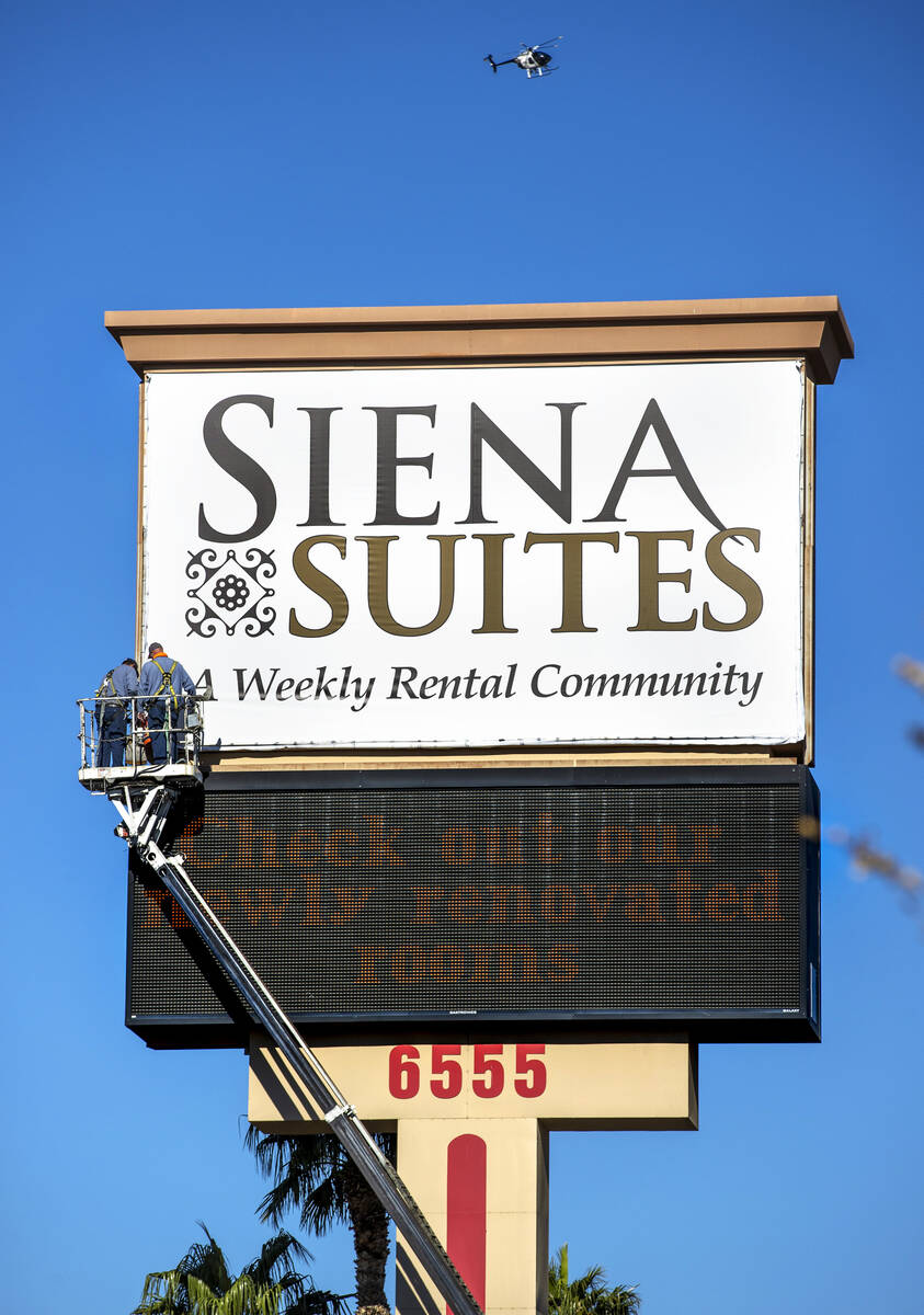 A crew works on the main sign out along Bounder Highway at the Siena Suites where Metro service ...