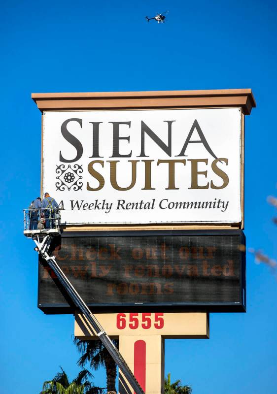 A crew works on the main sign out along Bounder Highway at the Siena Suites where Metro service ...