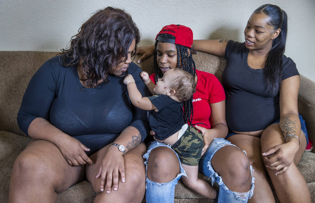 Imani Jones with her son Jay'zon Jones, 9 mos., with Kall'y Scott, 15, and Montrese Fletcher in ...