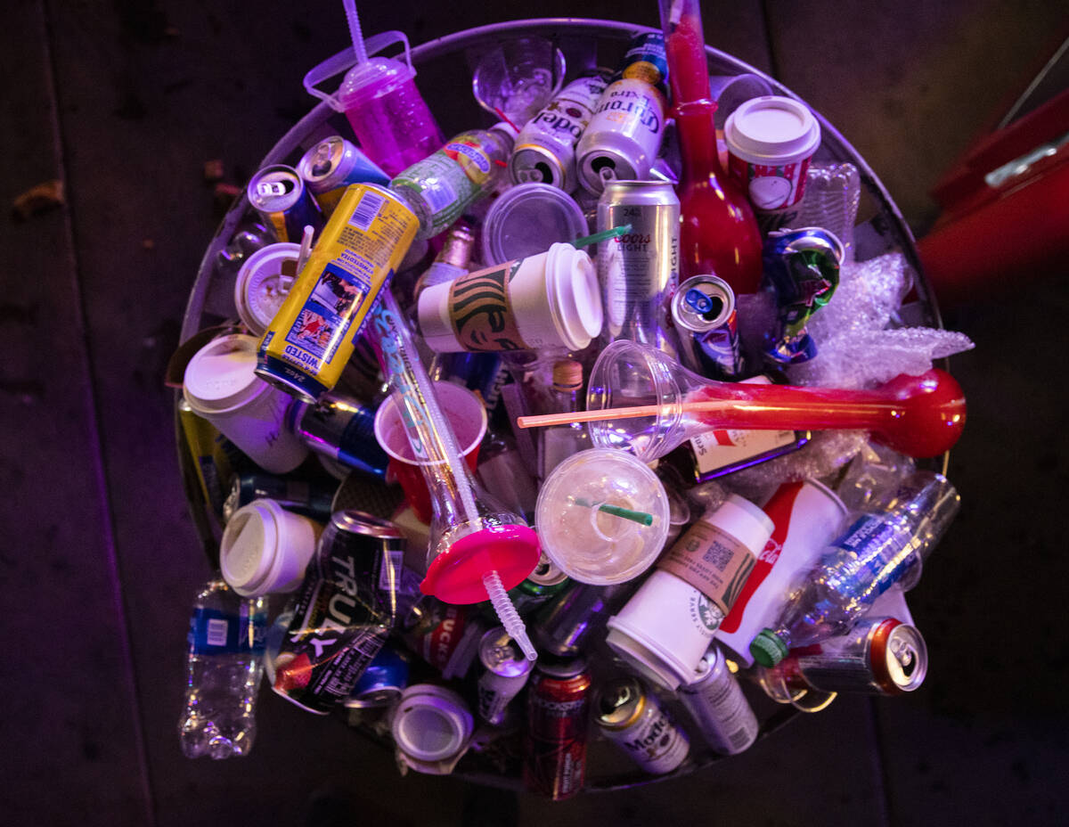 A trash can is filled to the brim with empty drinks on the Strip on New Year’s Eve on Fr ...