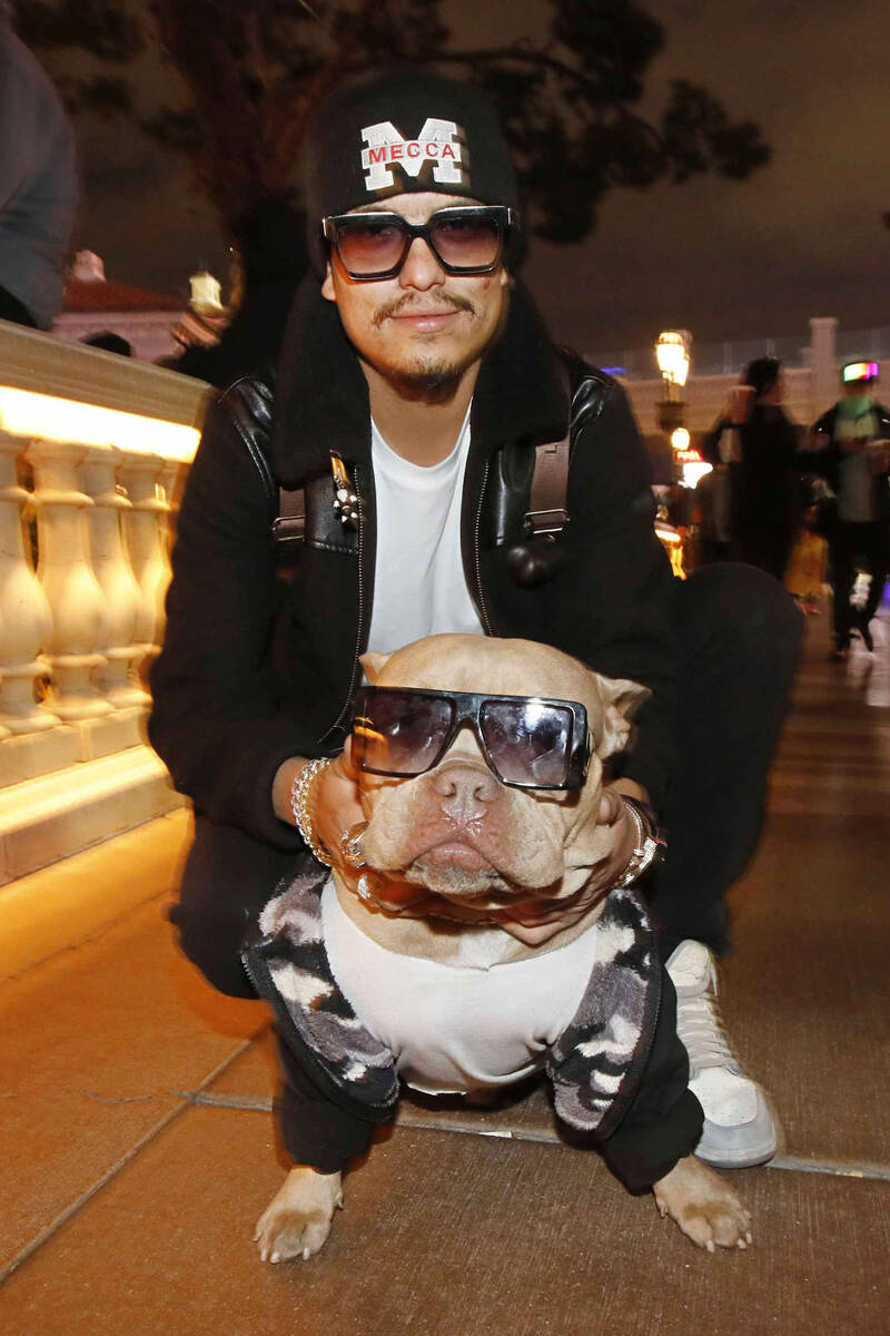 Oscar Sanchez of Mecca Calif. poses for a photo with his dog Kash in front of the fountains of ...