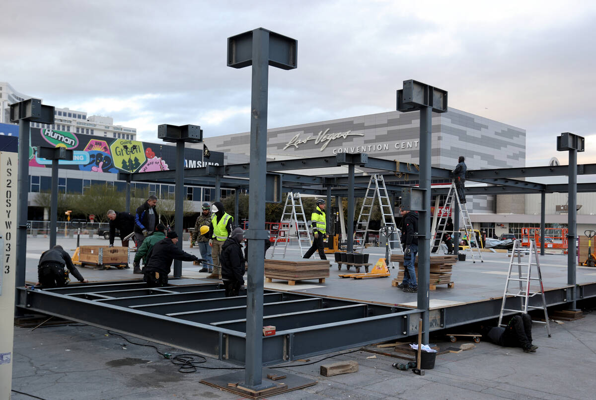 Workers prepare for CES at the Las Vegas Convention Center Thursday, Dec. 30, 2021. The trade s ...
