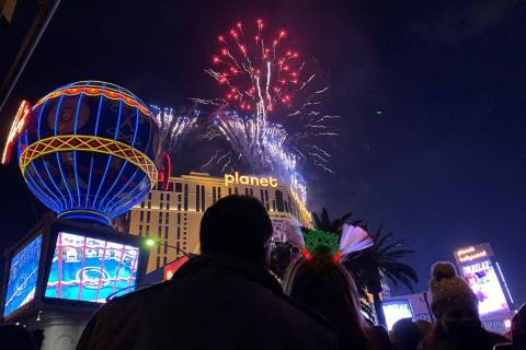 People watch fireworks during the New Year's celebration on Saturday, Jan. 1, 2022, on the Las ...