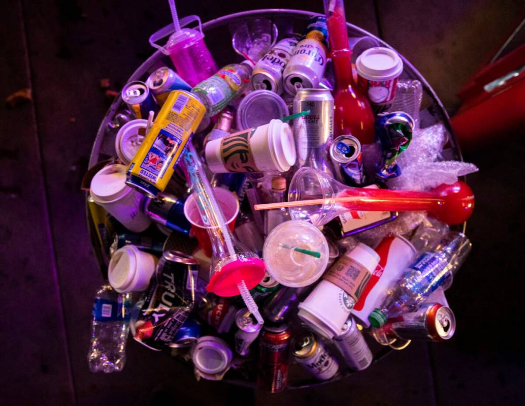 A trash can is filled to the brim with empty drinks on the Strip on New Year’s Eve on Fr ...