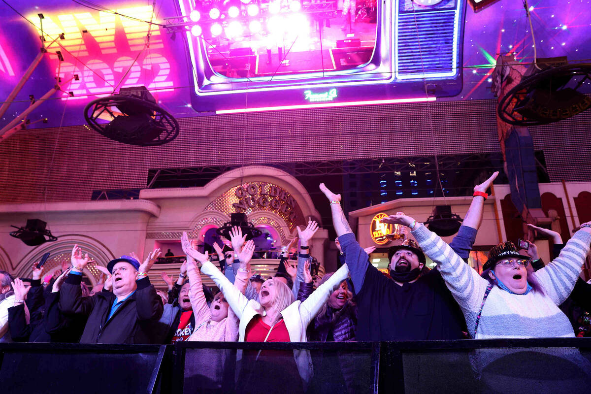Revelers dance to the Village People on New YearÕs Eve at the Fremont Street Experience in ...