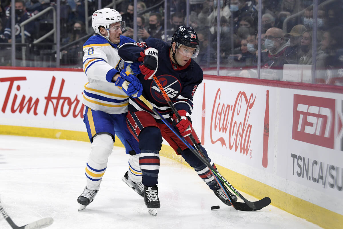 Winnipeg Jets' Paul Stastny (25) is checked by Buffalo Sabres' Robert Hagg (8) during the secon ...