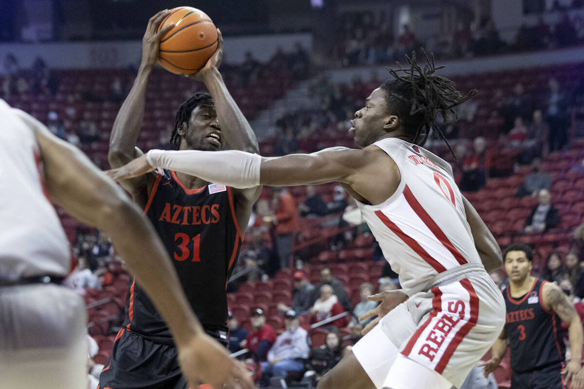 UNLV Rebels guardant  Victor Iwuakor (0) attempts to artifact  a changeable  by San Diego State Aztecs forwa ...