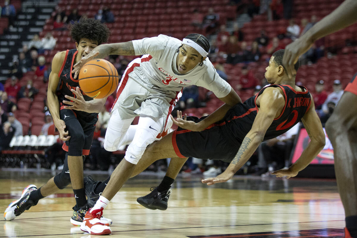 UNLV Rebels forward Donovan Williams (3) drives between San Diego State Aztecs guard Chad Baker ...