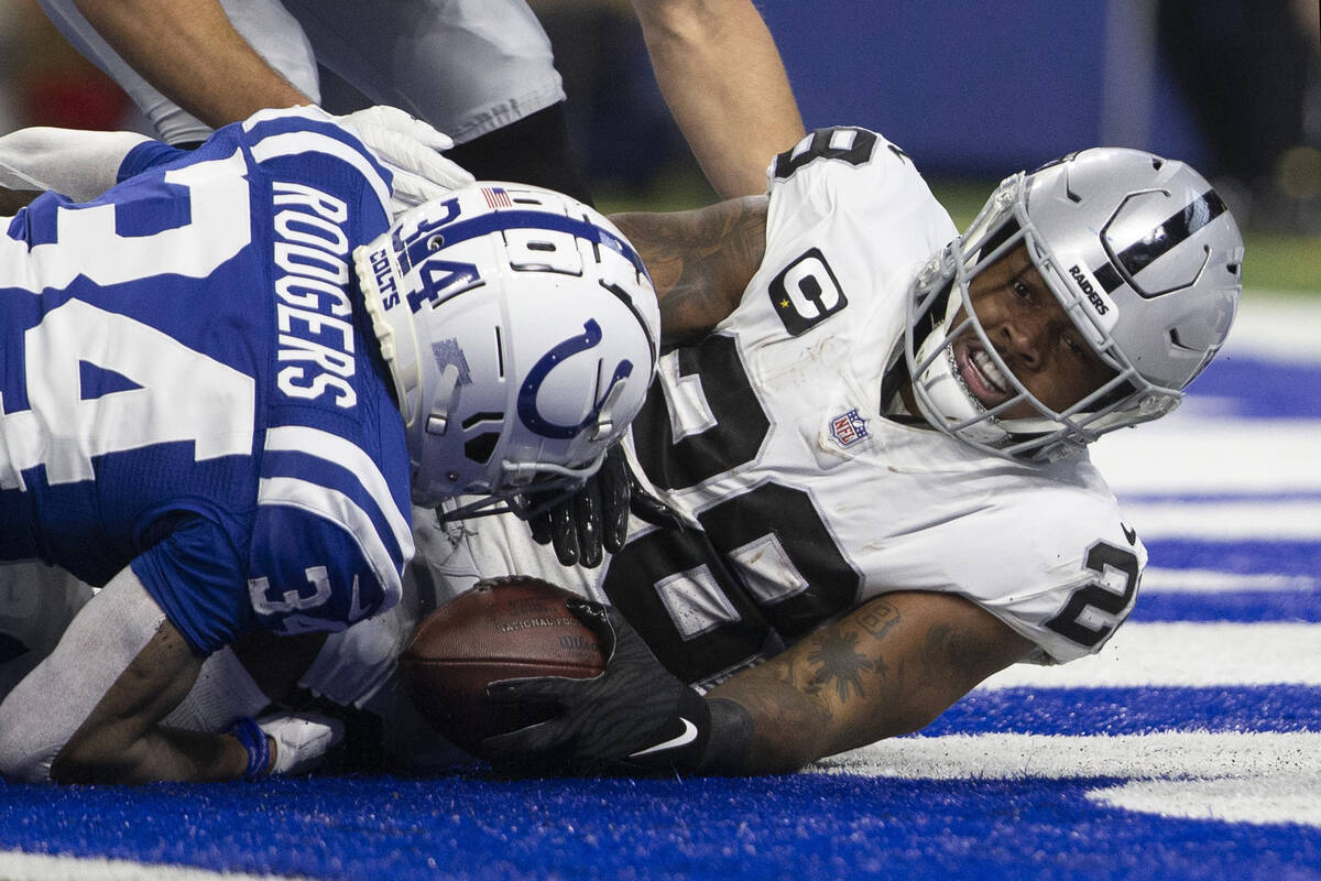 Raiders running back Josh Jacobs (28) scores a touchdown against Indianapolis Colts cornerback ...