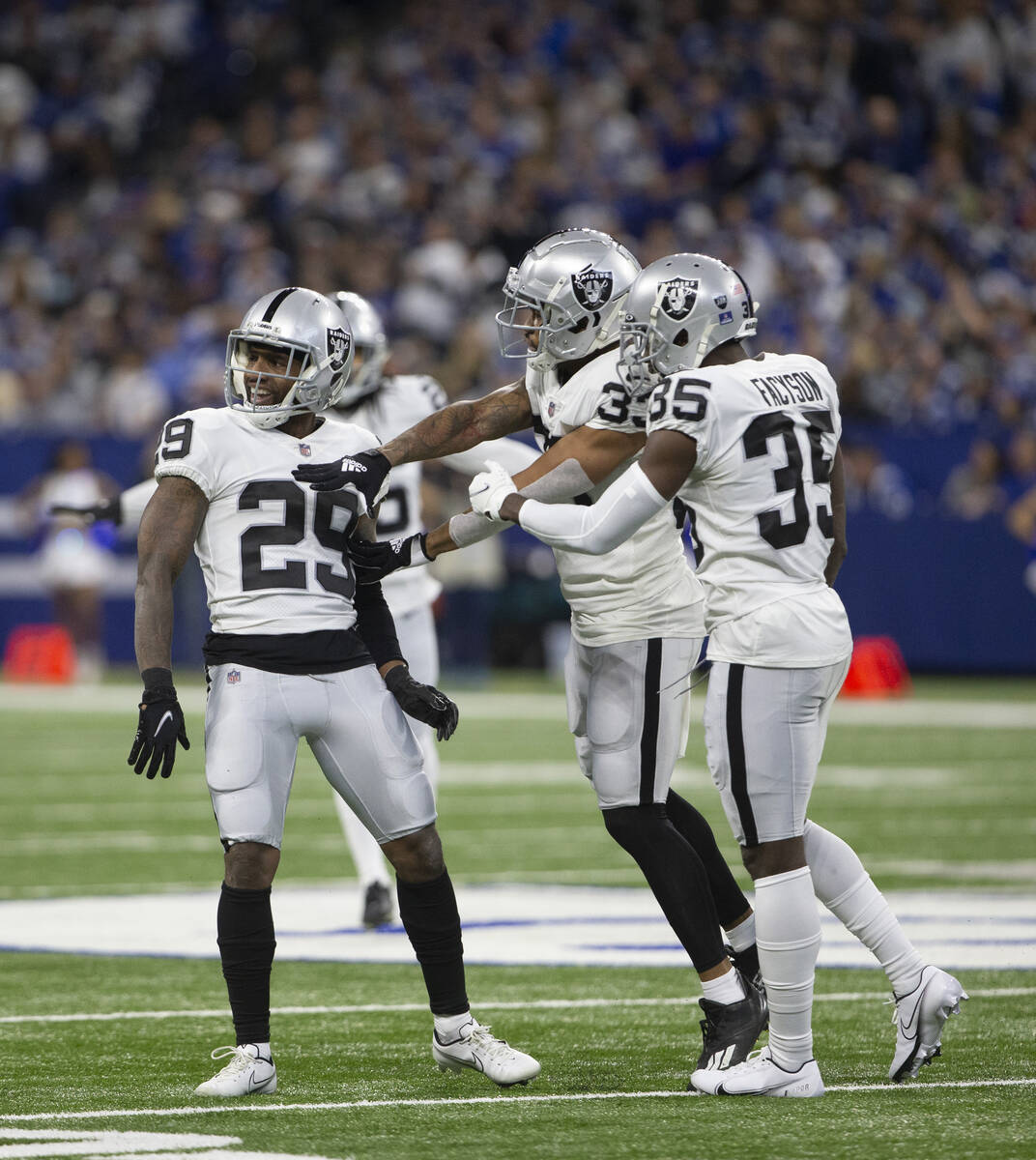 Raiders safety Roderic Teamer (33) and Raiders cornerback Brandon Facyson (35) celebrate a stop ...