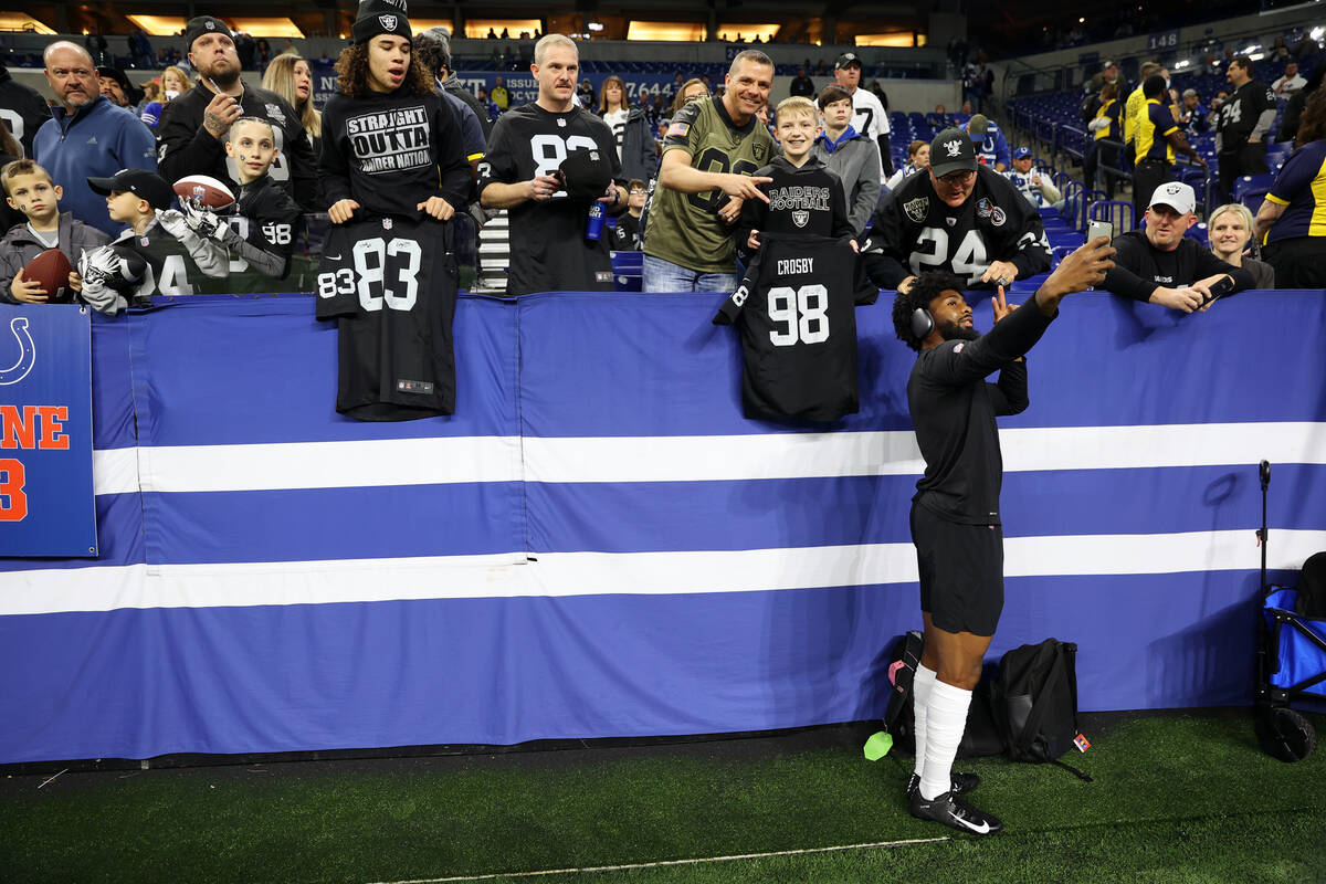Raiders cornerback Nate Hobbs (39) takes a photograph  with fans earlier  the commencement  of an NFL shot   ...