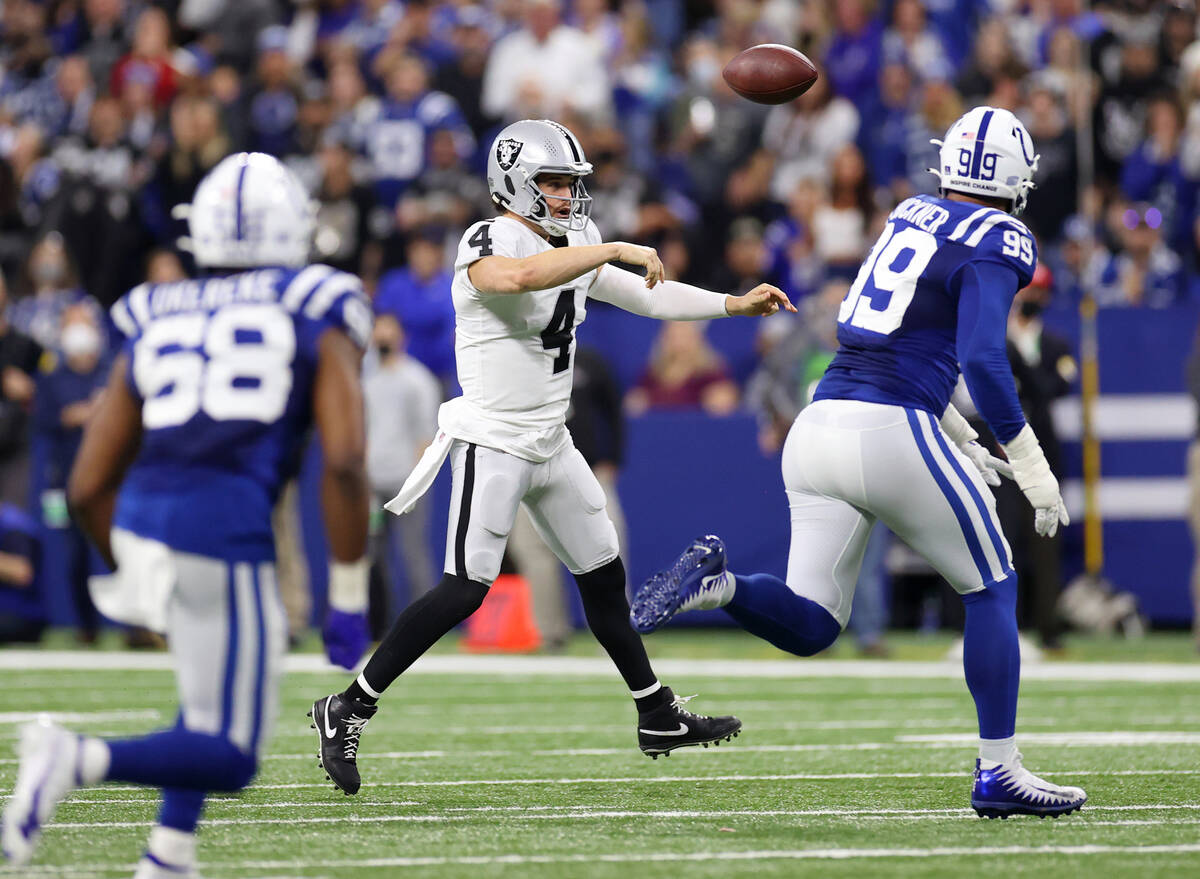Raiders backmost   Derek Carr (4) throws a walk  against the Indianapolis Colts successful  the archetypal  ha ...