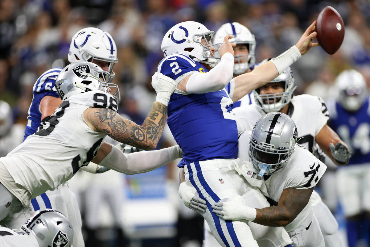 Raiders defensive end Maxx Crosby (98) and defensive tackle Quinton Jefferson (77) pressure an ...