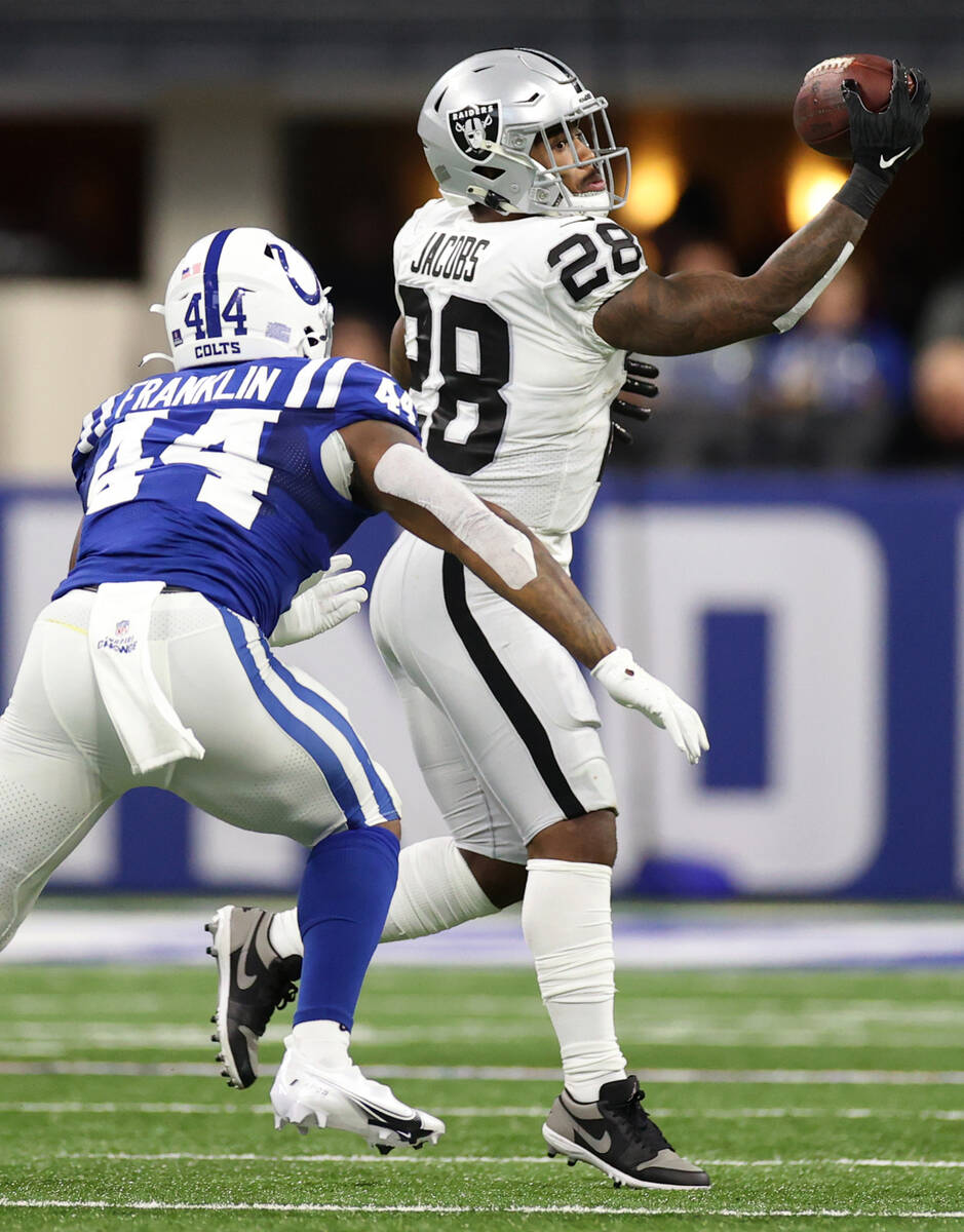 Raiders moving  backmost  Josh Jacobs (28) makes a drawback  nether  unit   from Indianapolis Colts outs ...